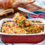 close view of rutabaga date and bacon stuffing in dish with spoonful sitting on top.