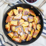 skillet of Kaiserschmarrn torn pancakes viewed from overhead.