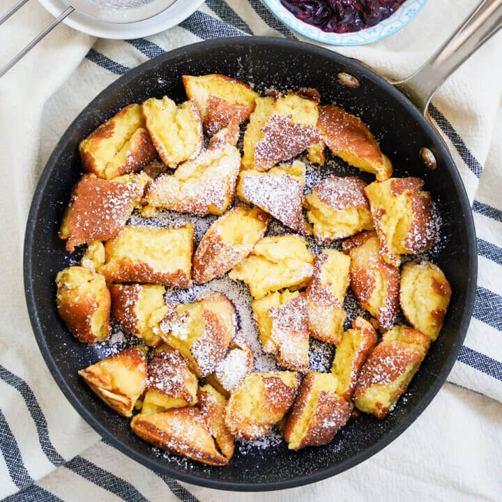skillet of Kaiserschmarrn torn pancakes viewed from overhead.