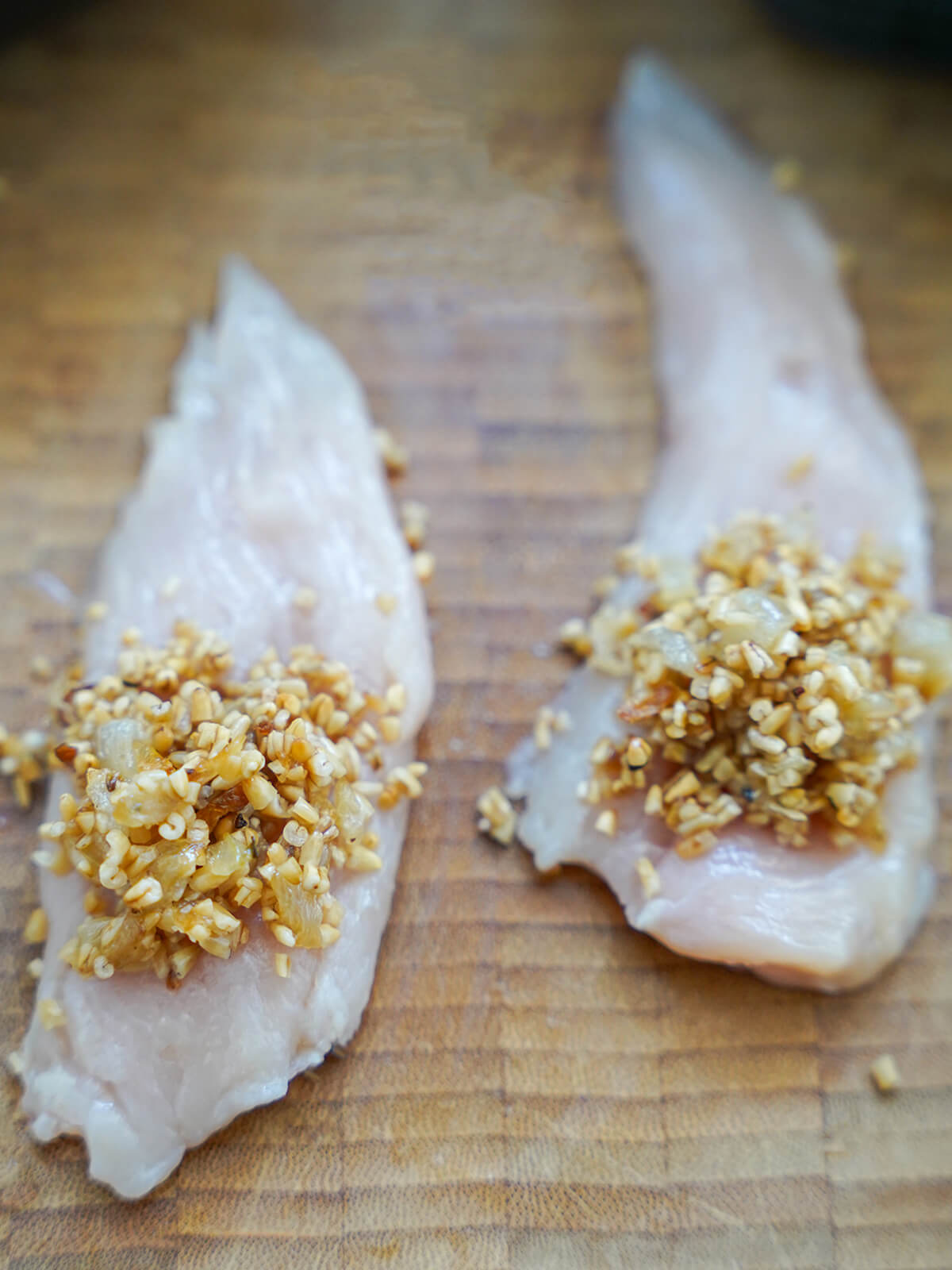 pieces of chicken topped with skirlie, oatmeal stuffing, before rolling up.