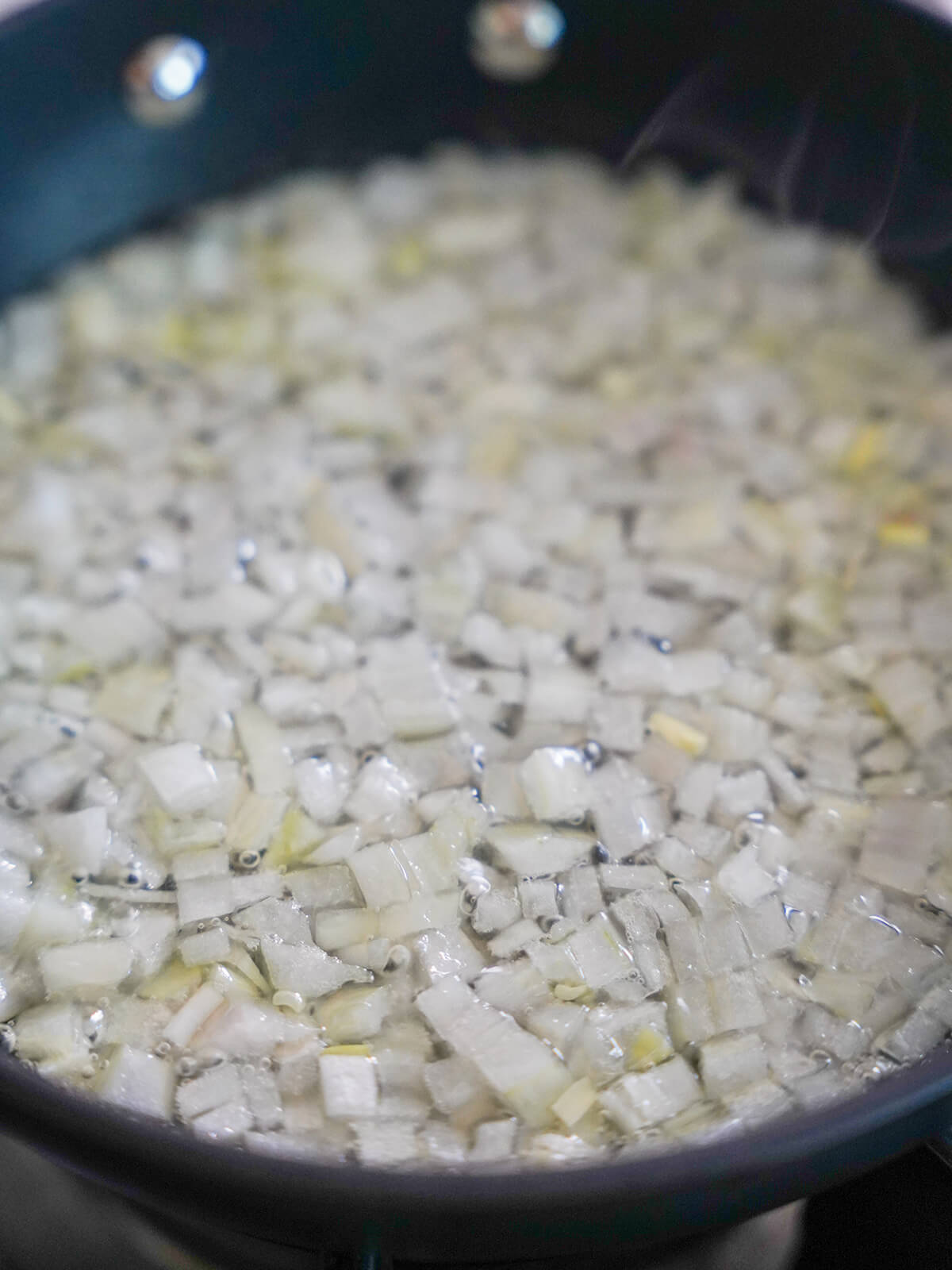 onion simmering in fat in skillet.