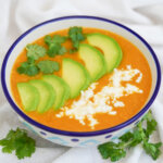 side view of bowl of locro de papa, Ecuadorean potato soup.