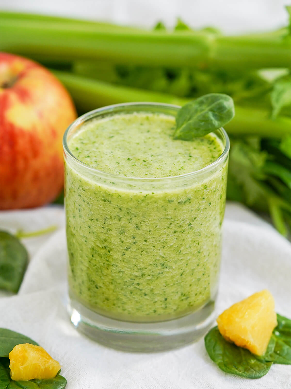 side, closer view of a glass of pineapple and spinach smoothie.