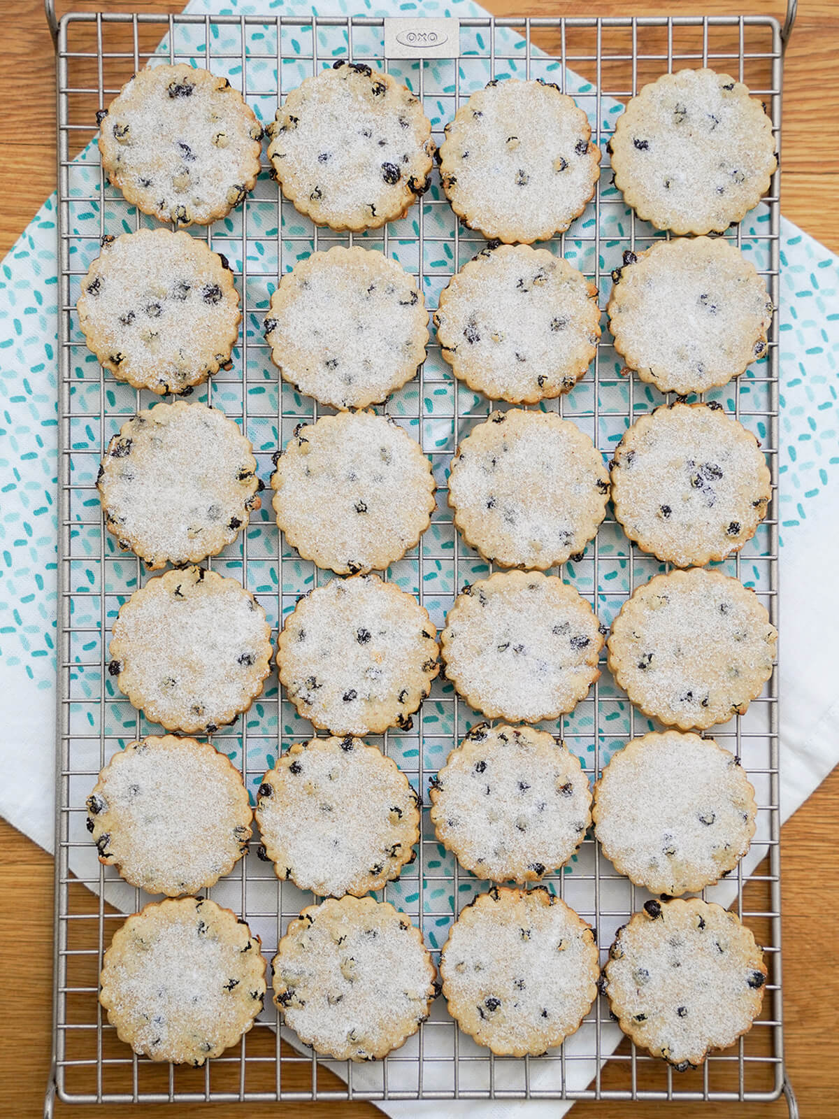 rows of Easter biscuits on cooling rack over cloth.