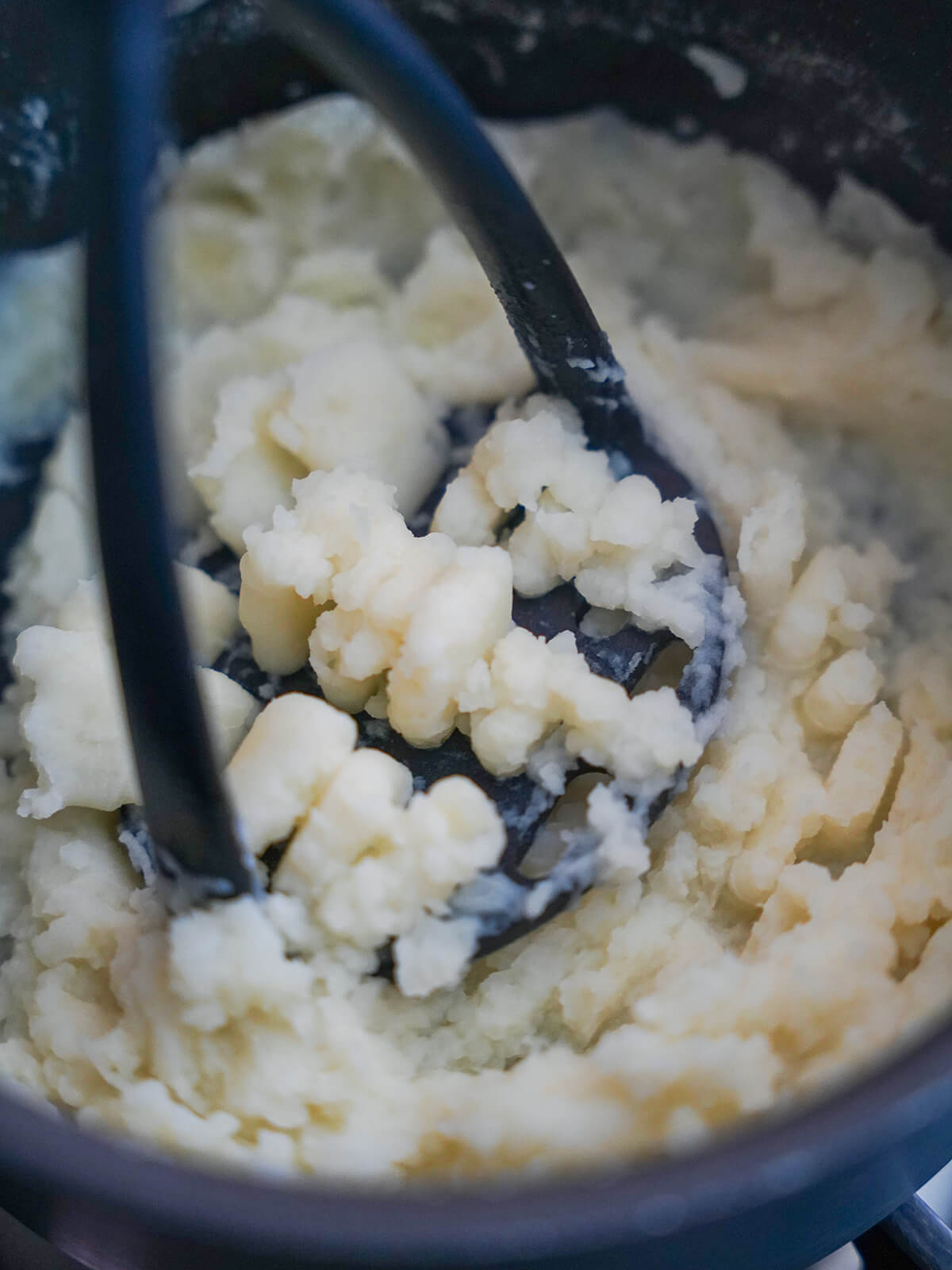 mashing vegetables for colcannon mashing potato to a smooth consistency.