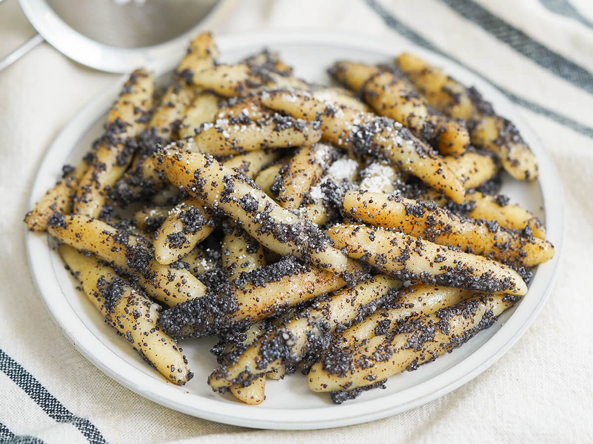 plate of Mohnnudeln, poppy seed potato noodles, dusted with a little powdered sugar.