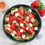 overhead view of bowl of spinach and strawberry salad.