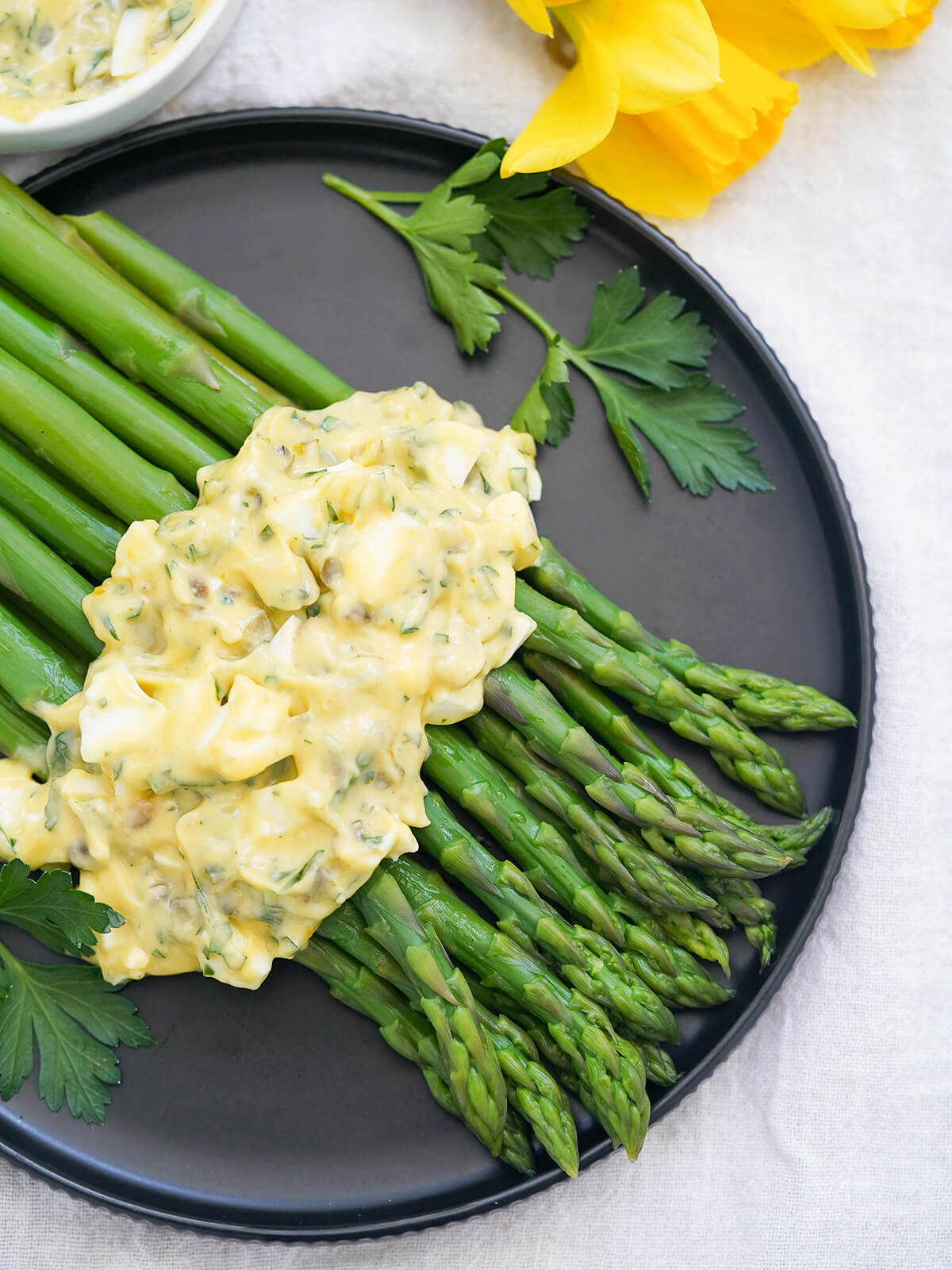 asparagus topped with sauce gribiche from overhead.