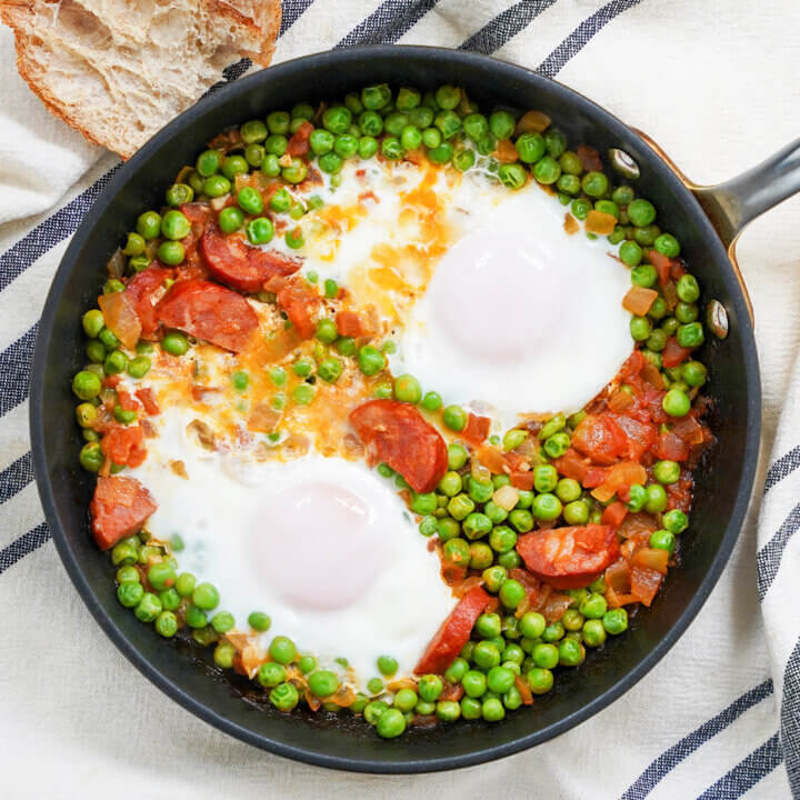 overhead view of a skillet of Portuguese peas and eggs.