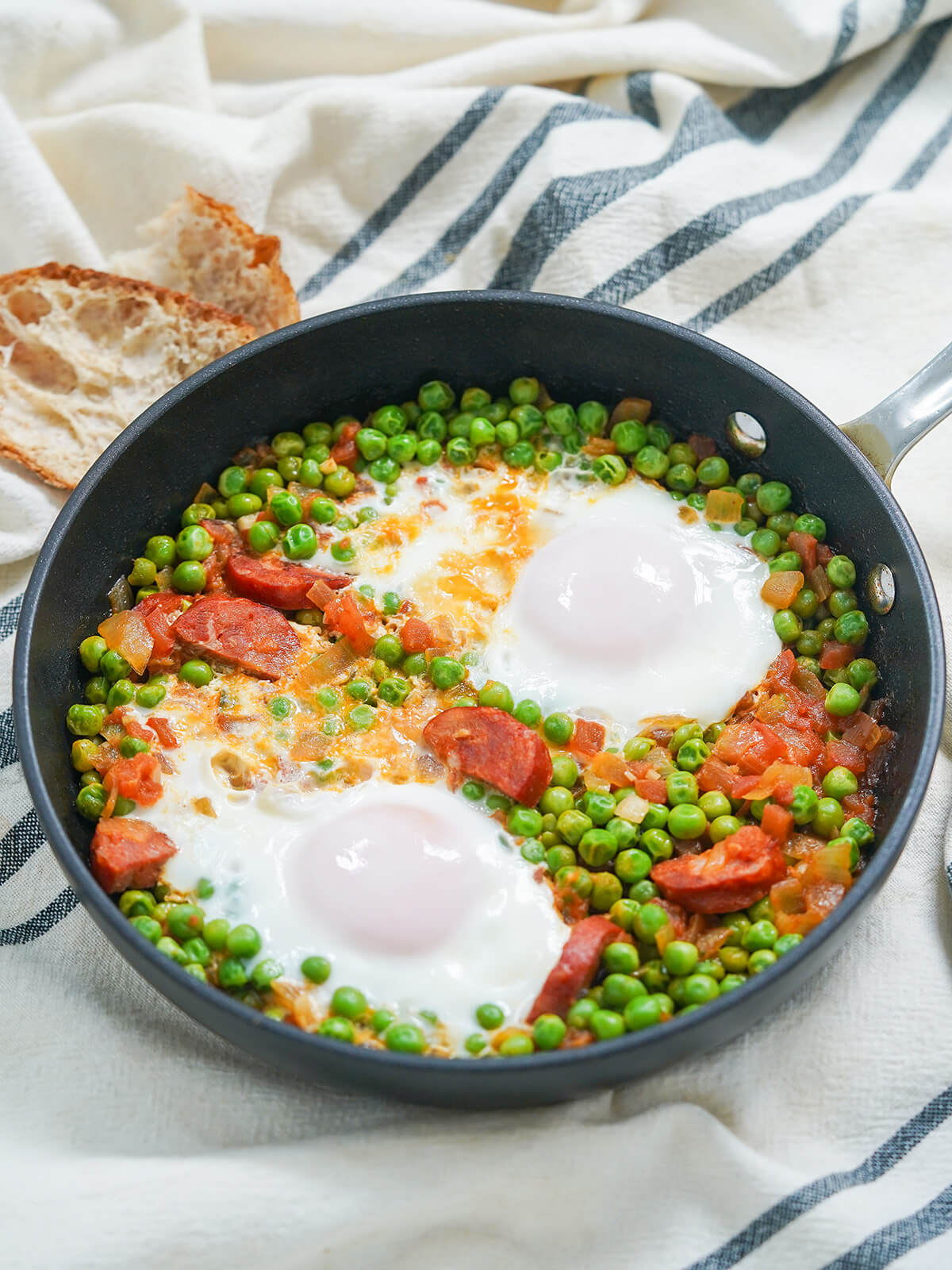 side view of skillet of Portuguese peas and eggs.