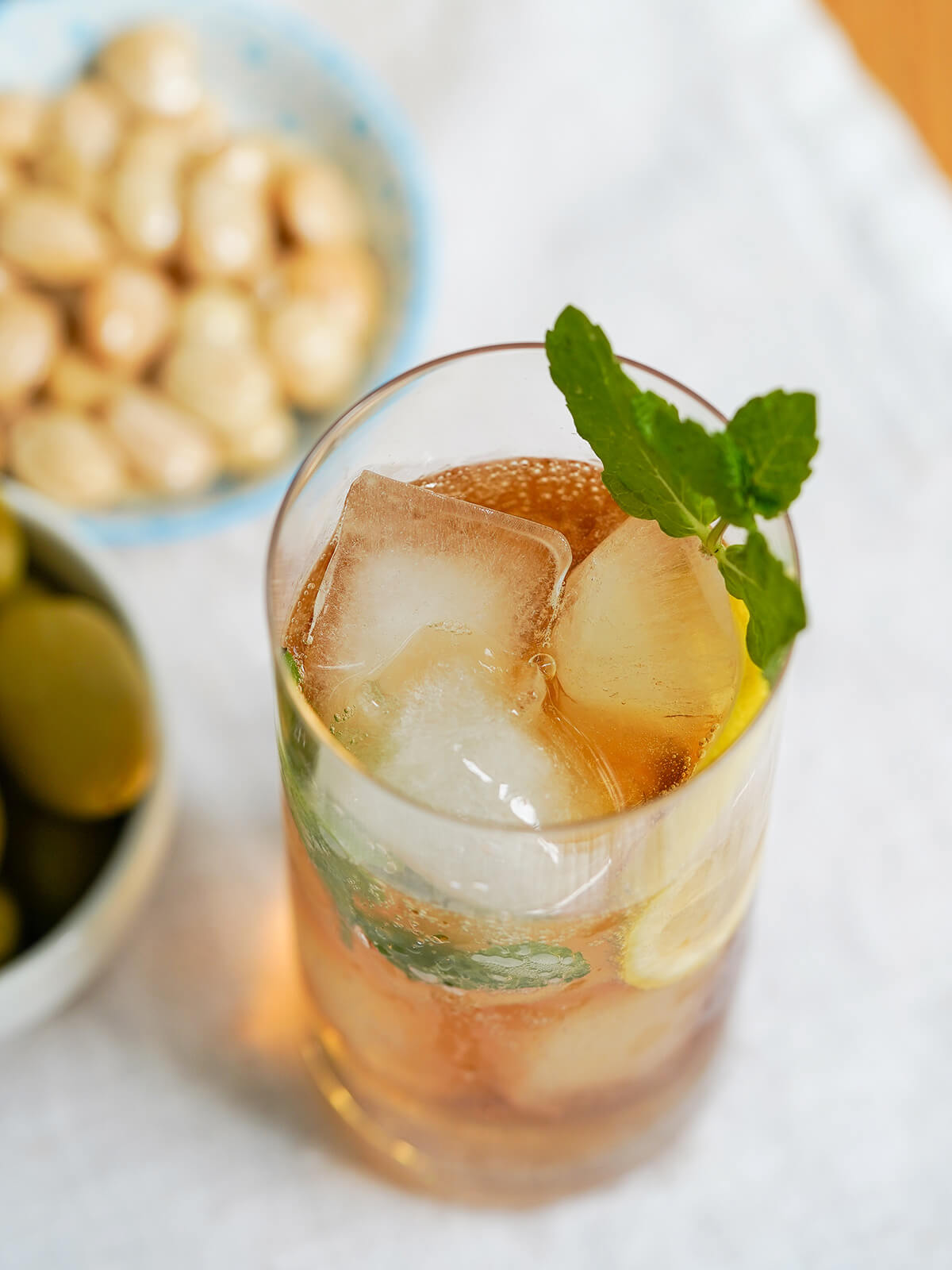 looking into glass with ice cubes and mint showing in top.