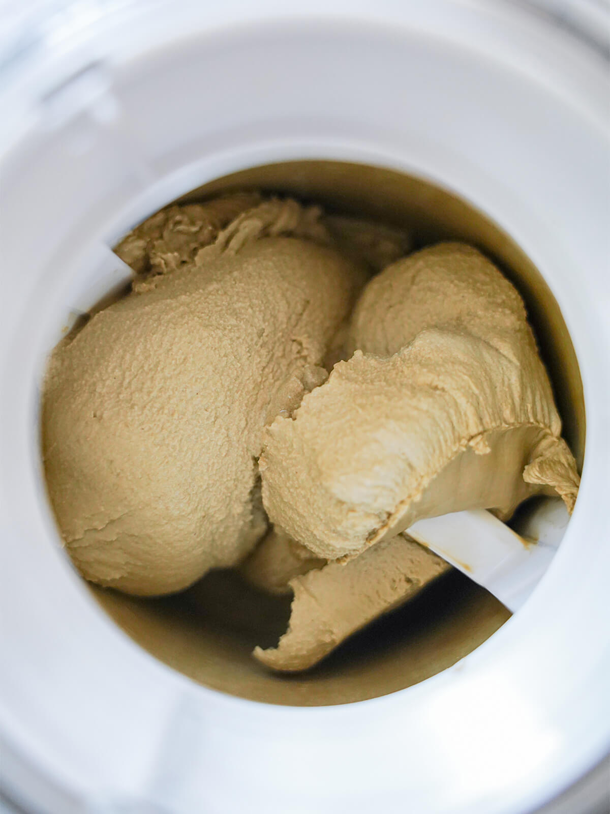 churning hojicha ice cream churning ice cream in ice cream maker.