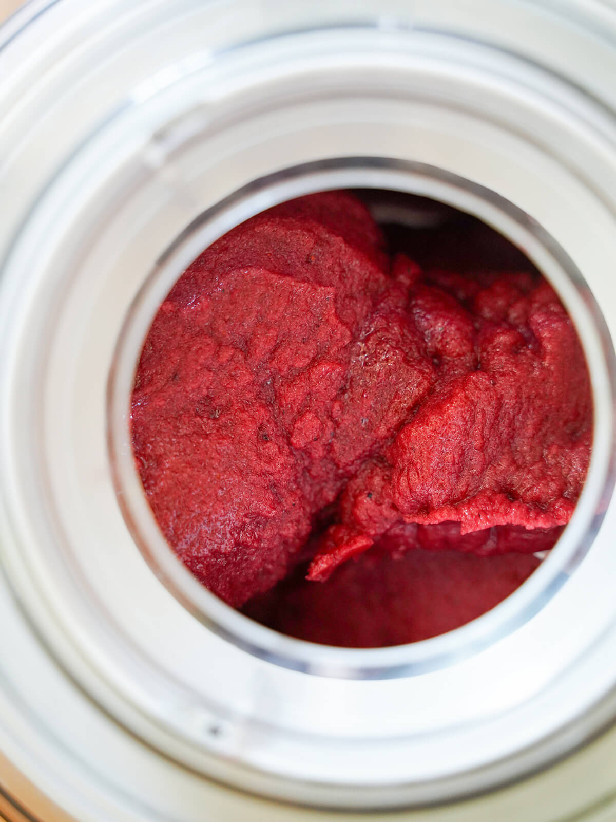 mixed berry sorbet churning in ice cream maker.