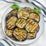 plate of marinated eggplant slices stacked together.