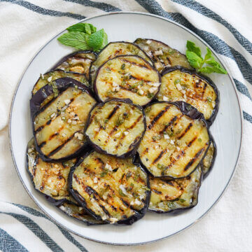 plate of marinated eggplant slices stacked together.