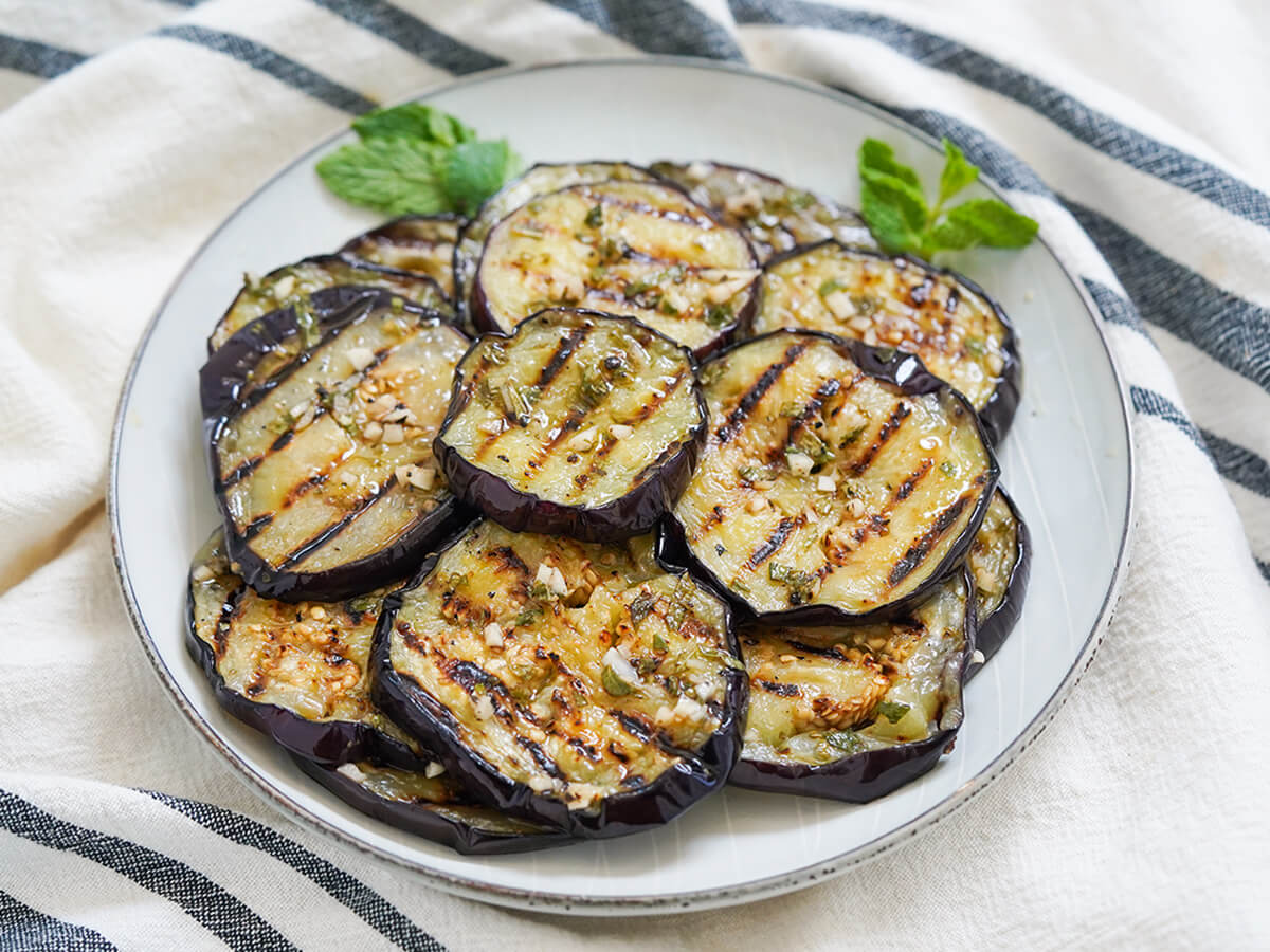 side view of plate of marinated eggplant.