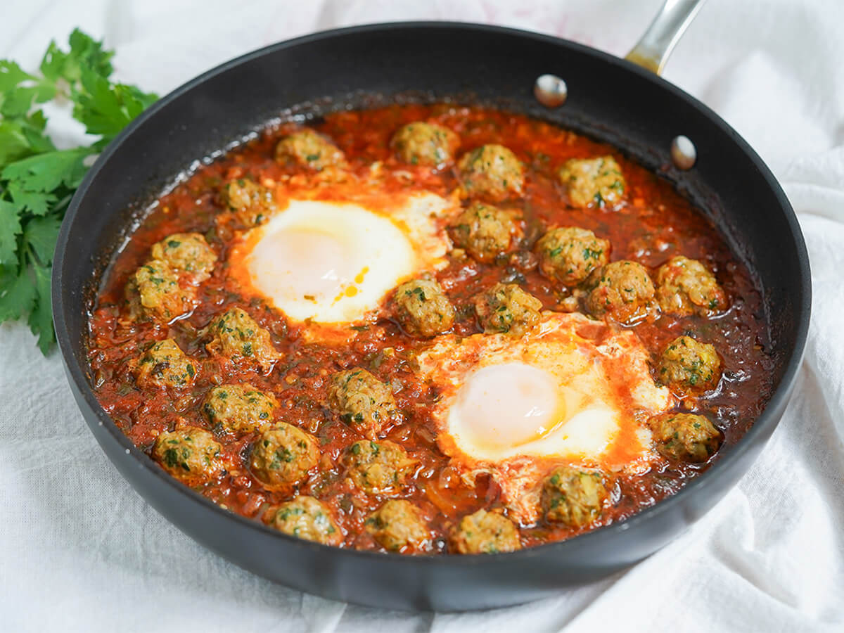 Kefta tagine Moroccan meatballs in tomato sauce with eggs in the sauce.