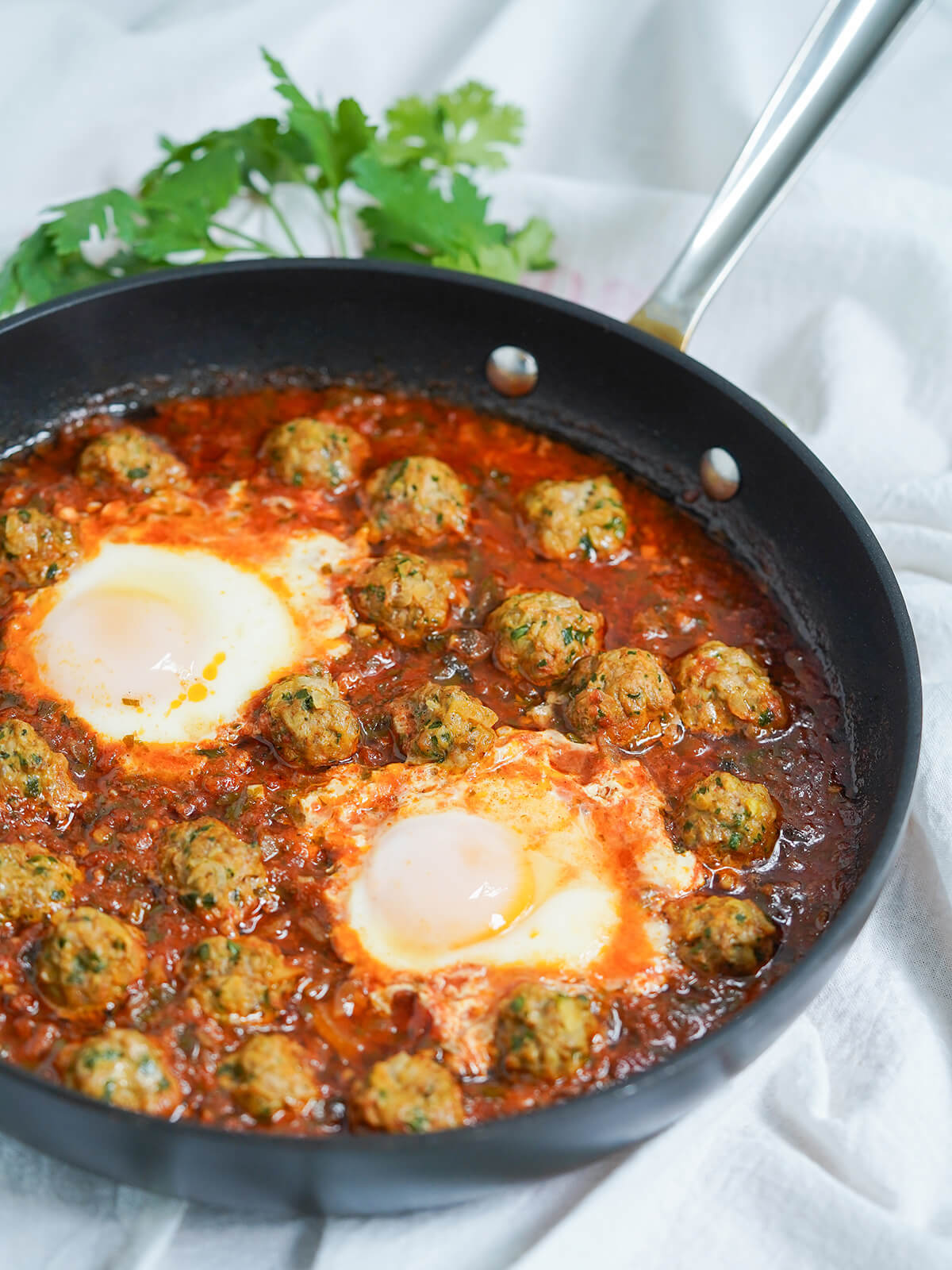 side view of skillet of Kefta tagine Moroccan meatballs.