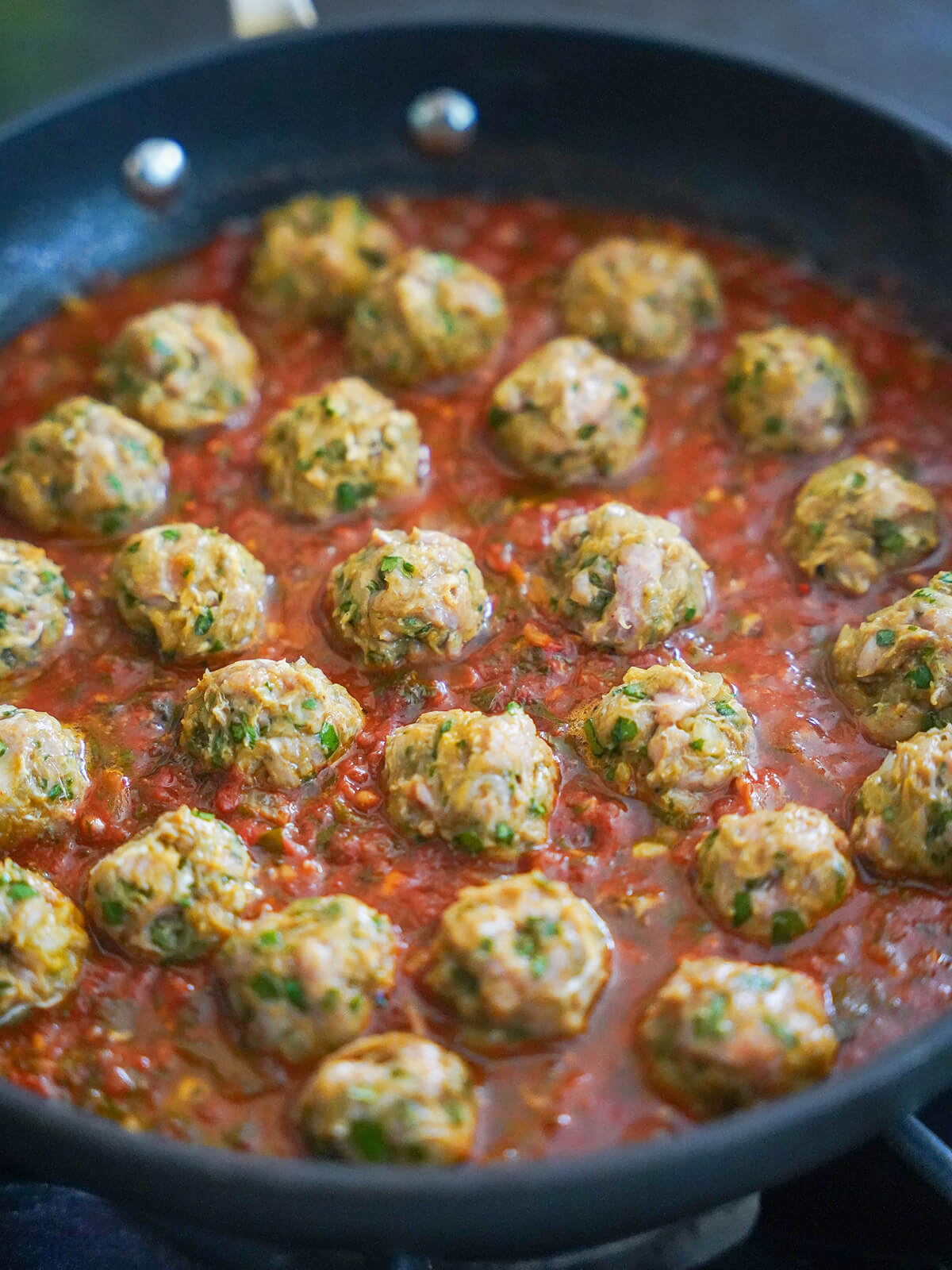 cooking meatballs in tomato sauce.