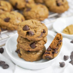 three hojicha chocolate chip cookies stacked together with part cookie to side.