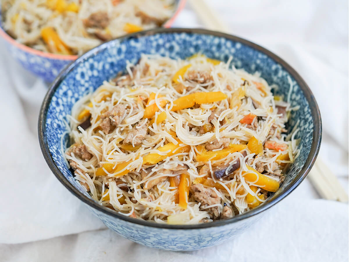 bowl of Taiwanese pumpkin rice vermicelli noodles side view of a bowl of Taiwanese pumpkin rice vermicelli noodles.