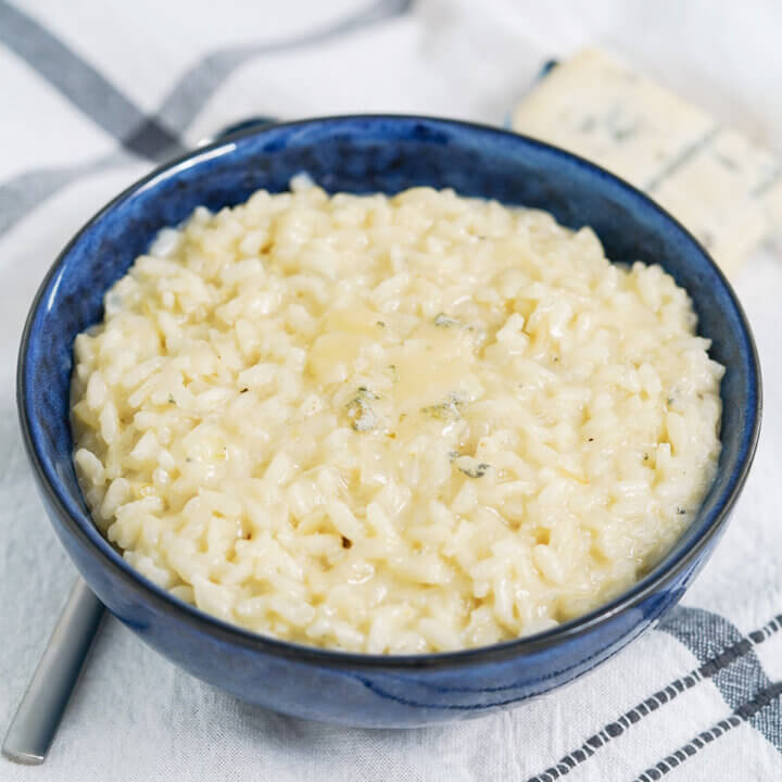 bowl of gorgonzola risotto with spoon under bowl.