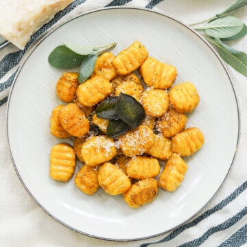 overhead view of plate of pumpkin gnocchi with sage browned butter.